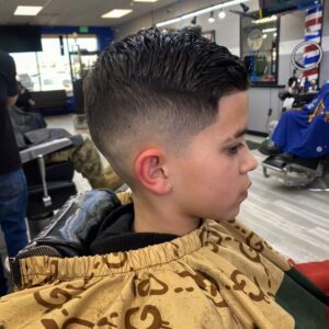 Child with fade haircut in barber chair