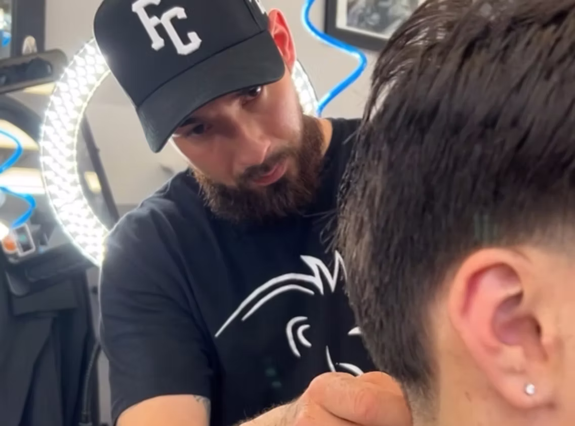 Barber giving a man a haircut